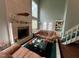 Inviting living room featuring a brick fireplace, comfortable seating, and natural light at 106 Orchard Rd, Henderson, NC 27536