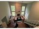 Spacious living room with a brick fireplace, large windows, and comfortable leather sofas at 106 Orchard Rd, Henderson, NC 27536