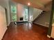 Spacious living room featuring a brick fireplace and staircase to the second floor at 106 Orchard Rd, Henderson, NC 27536