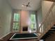 Bright living room with large windows and a white brick fireplace at 106 Orchard Rd, Henderson, NC 27536