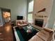 Cozy living room with high ceilings, brick fireplace, and access to the kitchen at 106 Orchard Rd, Henderson, NC 27536
