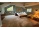 Inviting main bedroom featuring a sitting area, ceiling fan, and large window at 106 Orchard Rd, Henderson, NC 27536