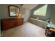 Main bedroom featuring a sitting area, window nook, and large dresser at 106 Orchard Rd, Henderson, NC 27536