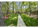 Landscaped backyard featuring a stone pathway leading to a gazebo at 108 Ridgepath Way, Cary, NC 27511