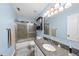 Light blue bathroom with a granite countertop, shower with glass doors, and modern fixtures at 108 Ridgepath Way, Cary, NC 27511