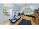 A spacious bedroom with hardwood floors, a large window, a daybed, and a sloped ceiling at 108 Ridgepath Way, Cary, NC 27511