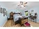 Spacious bedroom featuring hardwood floors, light blue walls, a ceiling fan, and a vanity at 108 Ridgepath Way, Cary, NC 27511