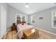 Cozy bedroom with hardwood floors, bright windows, and a comfortable bed at 108 Ridgepath Way, Cary, NC 27511