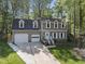 Traditional-style home features a two-car garage, dormer windows, and a well-manicured lawn at 108 Ridgepath Way, Cary, NC 27511