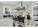 Modern kitchen featuring stainless steel appliances and marble backsplash at 108 Ridgepath Way, Cary, NC 27511
