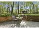 Outdoor patio with a table and chairs, lush greenery, and trees at 108 Ridgepath Way, Cary, NC 27511