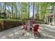 Stone patio with chairs, fire pit, and landscaped flower beds at 108 Ridgepath Way, Cary, NC 27511