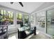 Sunroom with large windows showcasing backyard views and adjacent to the modern kitchen at 108 Ridgepath Way, Cary, NC 27511