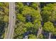 Aerial view of a house surrounded by lush trees near a quiet street, offering a private setting at 108 Sierra Dr, Chapel Hill, NC 27514