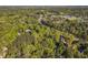 Expansive aerial shot of neighborhood homes, lush greenery, and roadways, near schools and tennis courts at 108 Sierra Dr, Chapel Hill, NC 27514