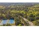 Vast aerial perspective featuring rolling landscape, distant buildings, and nearby tennis courts at 108 Sierra Dr, Chapel Hill, NC 27514