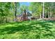 Expansive backyard with a screened porch and a well-manicured lawn at 108 Sierra Dr, Chapel Hill, NC 27514