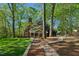 Large private backyard with a screened-in porch, mature trees, and a stone pathway at 108 Sierra Dr, Chapel Hill, NC 27514