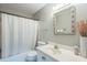 Functional bathroom with a shower-tub combo, classic vanity, and a decorative mirror adding charm at 108 Sierra Dr, Chapel Hill, NC 27514
