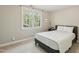 Comfortable bedroom with neutral tones, a large window, and a cozy bed, creating a relaxing atmosphere at 108 Sierra Dr, Chapel Hill, NC 27514