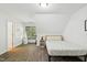 Cozy bedroom featuring wood floors, an attic ceiling, and a modern bed frame with a soft quilt at 108 Sierra Dr, Chapel Hill, NC 27514