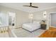 Serene bedroom with an elegant bed, stylish lighting, and an arched doorway leading to the ensuite bathroom at 108 Sierra Dr, Chapel Hill, NC 27514