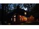 Inviting two-story brick home with a screened porch and a traditional chimney, softly lit at twilight at 108 Sierra Dr, Chapel Hill, NC 27514