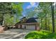 Well-maintained brick home featuring a two-car garage, mature trees, and a spacious driveway at 108 Sierra Dr, Chapel Hill, NC 27514