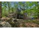 Backyard view of a brick home with a screened porch and stone pathway at 108 Sierra Dr, Chapel Hill, NC 27514