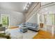 Spacious living room with a staircase, hardwood floors, a large window, and comfortable seating at 108 Sierra Dr, Chapel Hill, NC 27514