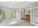 Bright living room featuring large windows, French doors, and access to the dining room at 108 Sierra Dr, Chapel Hill, NC 27514