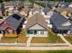 An aerial view of a lovely home with manicured lawn, picket fence, and colorful landscaping in a friendly neighborhood at 110 Plott Hound Dr, Clayton, NC 27520