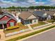 Suburban home with manicured lawn, white picket fence, and solar panels visible in a peaceful neighborhood setting at 110 Plott Hound Dr, Clayton, NC 27520