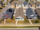 A high-angle shot displaying a well-maintained house with neat lawn and a charming picket fence, nestled in a suburban setting at 110 Plott Hound Dr, Clayton, NC 27520
