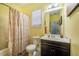 Yellow bathroom featuring a vanity, mirror, and toilet with a bathtub in the background at 110 Plott Hound Dr, Clayton, NC 27520