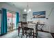 Bright dining room features stylish decor, access to outdoor patio, and hardwood floors at 110 Plott Hound Dr, Clayton, NC 27520
