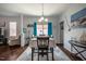 Formal dining room with a six-place table, a decorative rug, and adjacent living room at 110 Plott Hound Dr, Clayton, NC 27520