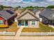 Charming single-story home with a well-manicured lawn, picket fence, and welcoming blue chairs on the front porch at 110 Plott Hound Dr, Clayton, NC 27520