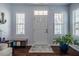 Bright foyer with dark hardwood floors, neutral walls, and ample natural light streaming through large windows at 110 Plott Hound Dr, Clayton, NC 27520