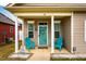 Inviting front porch with blue chairs and decorative accents create a cozy entrance to this charming home at 110 Plott Hound Dr, Clayton, NC 27520