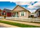 Charming single-story home featuring a white picket fence and well-maintained lawn under a partly cloudy sky at 110 Plott Hound Dr, Clayton, NC 27520