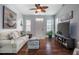Inviting living room with hardwood floors, neutral walls, comfortable seating, and abundant natural light at 110 Plott Hound Dr, Clayton, NC 27520