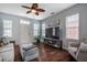 Bright living room with hardwood floors, natural light, comfortable seating, and a large entertainment center at 110 Plott Hound Dr, Clayton, NC 27520
