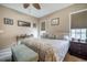 Well-lit main bedroom with windows, ceiling fan, neutral tones and comfortable furnishings at 110 Plott Hound Dr, Clayton, NC 27520