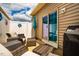 Inviting outdoor patio area with wicker furniture, sliding glass doors, and a Weber grill for easy entertaining at 110 Plott Hound Dr, Clayton, NC 27520