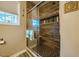 Modern bathroom shower with stylish tiling, glass door, and convenient built-in shelving at 110 Plott Hound Dr, Clayton, NC 27520