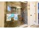 Shower featuring stylish tiling, glass door, built-in shelving, and turtle-themed towels at 110 Plott Hound Dr, Clayton, NC 27520