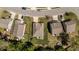 Aerial view of a home showcasing its roof, lawn, landscaping, and proximity to nearby residences and street at 112 Pink Dogwood Ln, Mebane, NC 27302