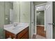 Bathroom with white vanity, mirror and wood-look floors at 112 Pink Dogwood Ln, Mebane, NC 27302