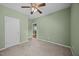 Bedroom with neutral carpet, ceiling fan and white door at 112 Pink Dogwood Ln, Mebane, NC 27302
